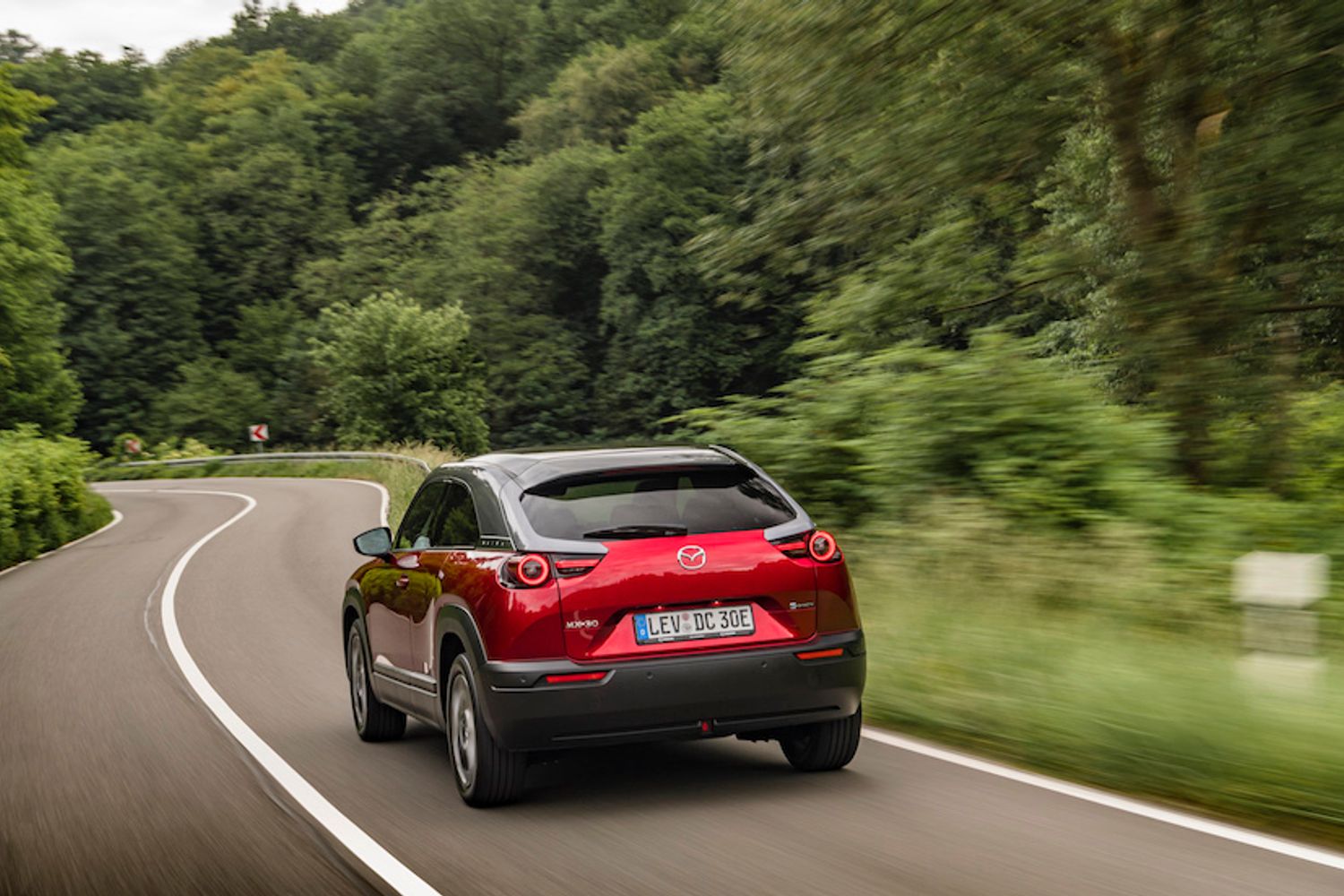 Red Mazda CX30 rear driving